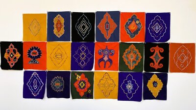 Voices in Thread, Migrant Women's Art Group A collection of vibrant textile artworks with a combination of symbols.