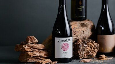 Bottles of wine next to Canberra soil