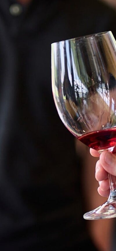 A glass of red wine is swirled