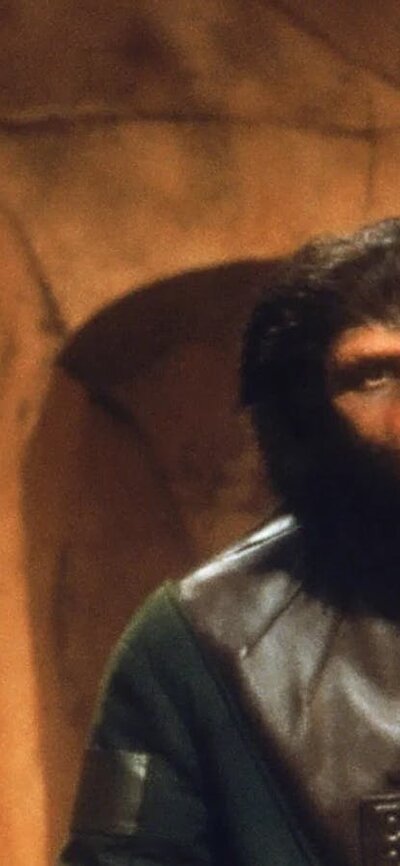 Double Feature: Barbarella + Planet of the Apes (35mm), 24 July, 2026 Two ape looking figures facing a man wearing a metal collar