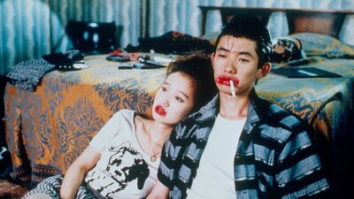 Double Feature: Mystery Train + Night on Earth, 28 August, 2026 A couple looking exhausted leaning on a bed sitting on floor, both wearing red lipstick