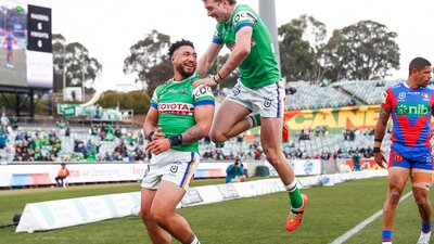 Canberra Raiders players Simi Sasagi and Jed Stuart celebrating a try.