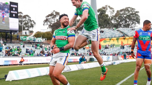 Canberra Raiders players Simi Sasagi and Jed Stuart celebrating a try.