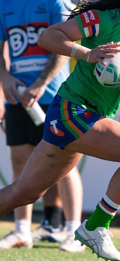 Canberra Raiders player Madison Bartlett running the ball.