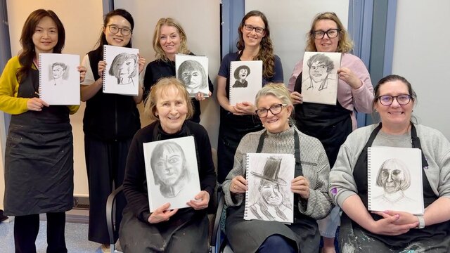 Workshop participants showing off their drawings Workshop participants showing off their drawings