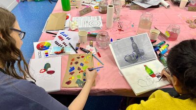 Paint and chat students painting together Paint and chat students painting together