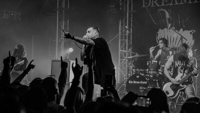 Dream On Dreamer band performing infront of a busy crowd from the crowd pov.