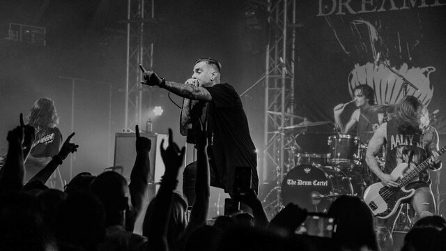 Dream On Dreamer band performing infront of a busy crowd from the crowd pov.