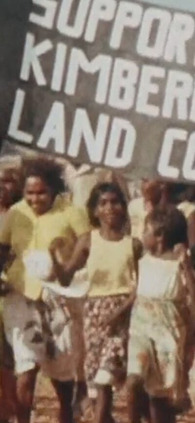 Protest with group of people holding sign saying support to Kimberley land council