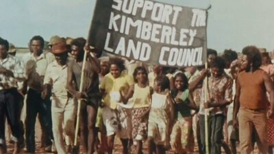 On Sacred Ground (1980) Protest with group of people holding sign saying support to Kimberley land council