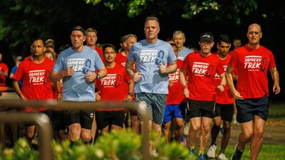 Group of people running in Dusk till Dawn tshirts