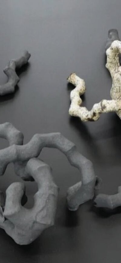 A long curvy ceramic form twisting into a knot shape