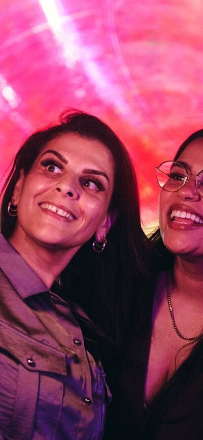 Two females capturing a selfie in front of an Enlighten installation