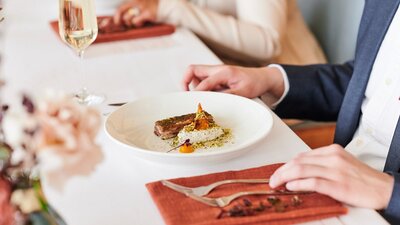 A plate of food on a white table cloth.