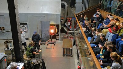 Crowds watching glassblowing