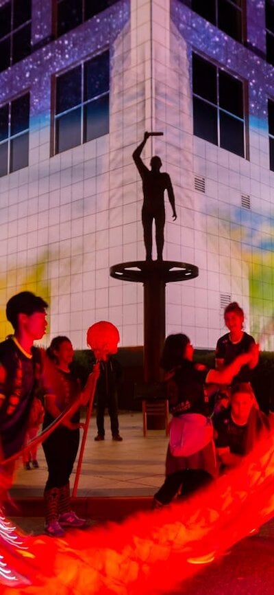 Questacon illuminated with Chines dragon dancers