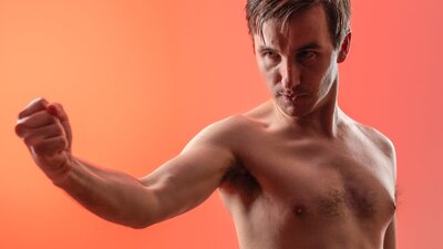 A naked male clenches his fist passionately A naked male clenches his fist passionately