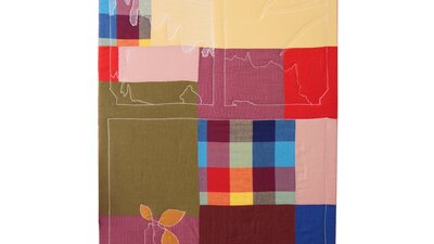 Rectangle patchwork textile artwork with blue, yellow, red and green colours as well as thread.
