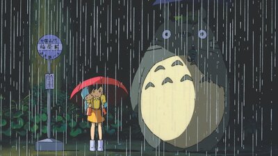 Animation of a young girl standing next to a large creature, both holding umbrellas for the rain