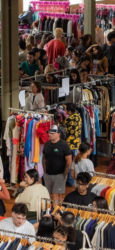 Pictured is a birds eye view of one of our markets, lots of people and clothing.