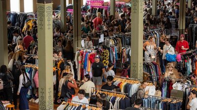 Pictured is a birds eye view of one of our markets, lots of people and clothing.