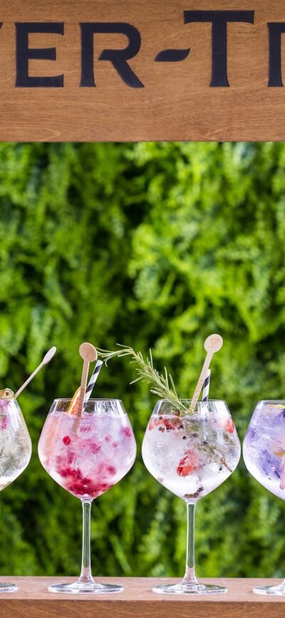 Fever-Tree outdoor bar with a row of gin and tonic cocktails in large glasses