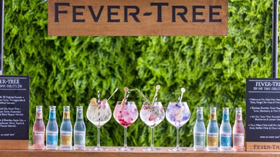Fever-Tree outdoor bar with a row of gin and tonic cocktails in large glasses