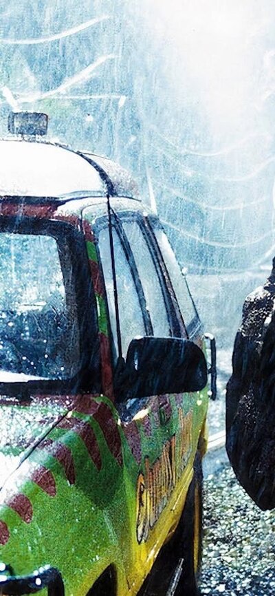 Dinosaur looking into a car