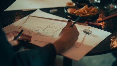 Drawing with hand holding pencil