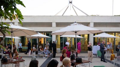 The Queen's Terrace at dusk filled with people.