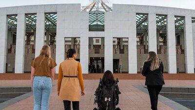 4 people in front of Parliament House.