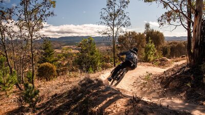 Racer in front of view from Stromlo into the Brindabellas