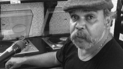 Mac Silva at control desk of Sydney's first Indigenous radio station, Radio Redfern