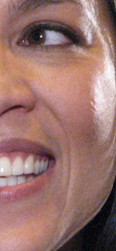 Kate Ceberano (2007) Close -up of Kate Ceberano, smiling, photo of a ship in background
