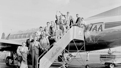 Black and white archival photo of a German family boarding a plane