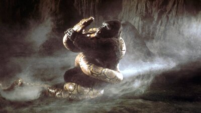 Large ape being attacked by a large snake