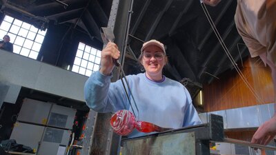 Participant in glassblowing class