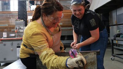 Make Your Own glassblowing class at Canberra Glassworks teacher and participant blowing glass in the Hotshop