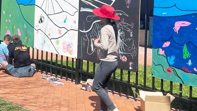 Kids working on colourful murals
