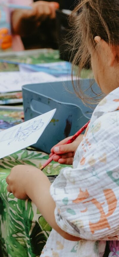 Children sitting around a table doing colouring in activities