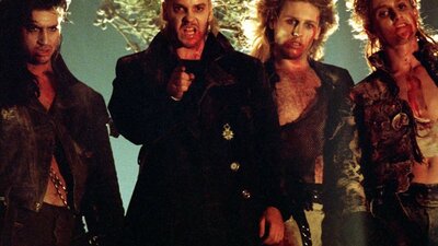 Four men standing covered in blood and gore