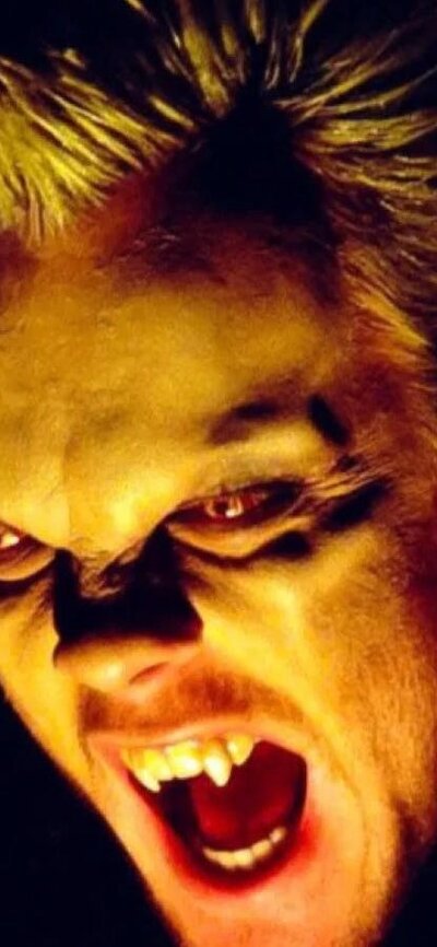 Close up of vampire baring teeth with glowing eyes
