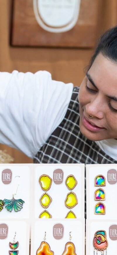 Tiere + Co looking at her display of earrings