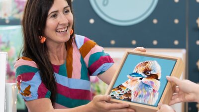 Art By Sarah showing a customer her artwork