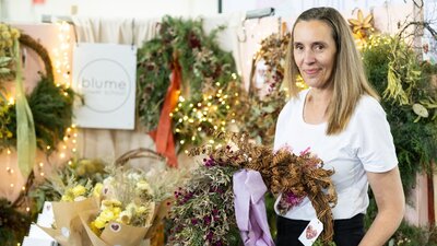 Blume Flower School holding a wreath