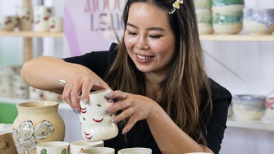 Mooody Lemon holding a ceramic cup