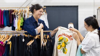 Al Elé showing a customer a jacket