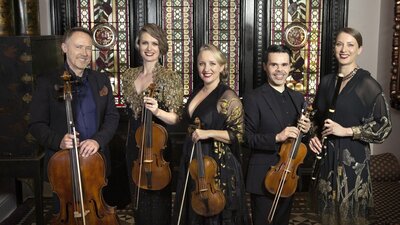 The Australian Haydn Ensemble A group of five classical musicians pictured un a grand old house, including stained glass doors.