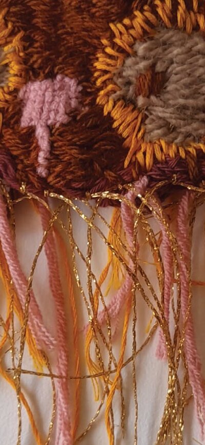 A textile wall hanging owl in shades of brown
