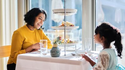 Mother and young daughter enjoying high tea at Parliament House